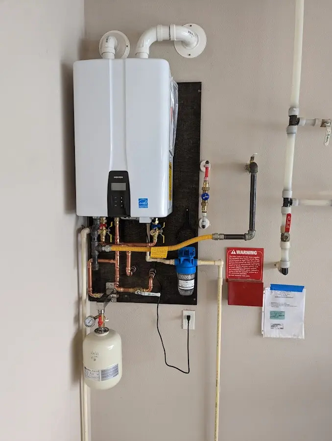 Professional plumber installing copper piping in a Canton home